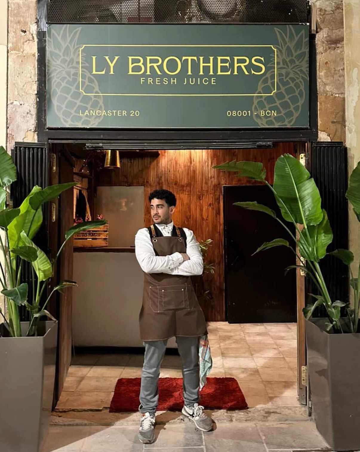 Miguel, the owner, standing at the entrance of LY Brothers